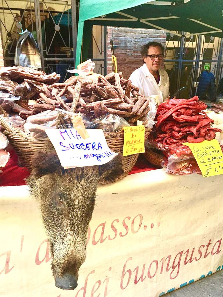Local salumi and wild boar products at Montepulciano market in Tuscany