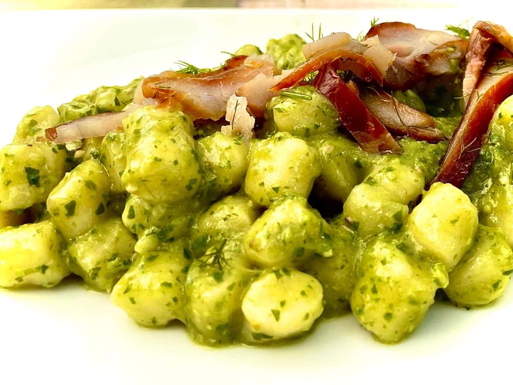 Plate of traditional Umbrian and Tuscan food with regional wine, representing local culinary experiences along day trips from Villa Gioiella.