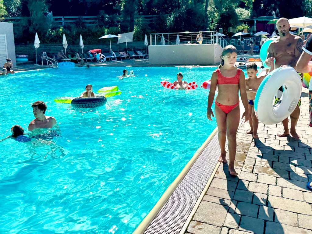Children swimming in the thermal-mineral pools at Piscine di Sarteano in Tuscany.
